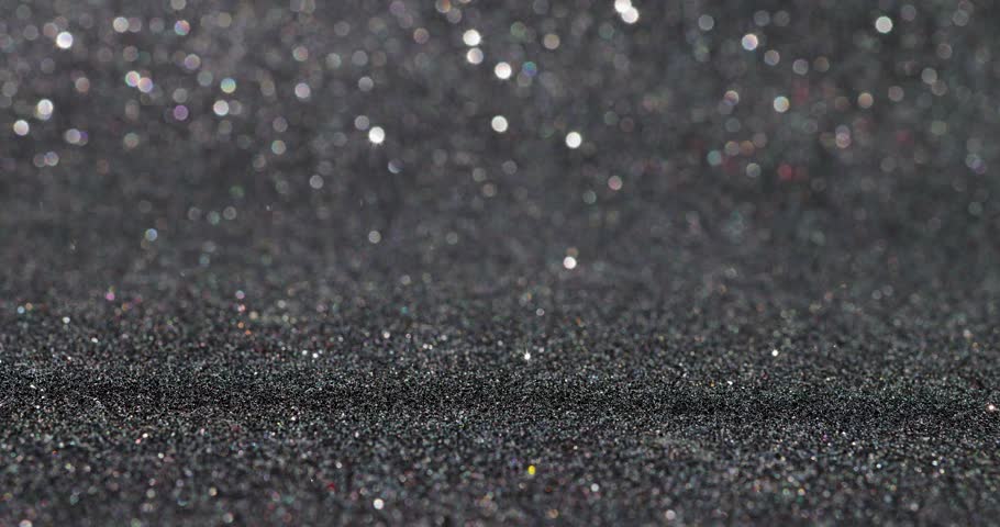 Footage of a red block with a black glittery background showing the number 1 on a block being put down and taken back up again