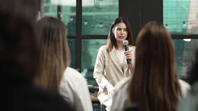Business woman Speaker Presenting with Microphone to Audience in Office. Speaking, Leadership, Communication Skills and Development in Corporate Concept. - Powered by Shutterstock - Get 15% off with code: PIKWIZARD15