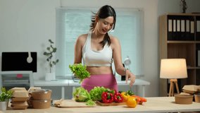 Beautiful Asian woman holds a bowl of healthy vegetable and fruit salad. Beautiful girl in fitness sportswear likes to eat vegetables after exercising for health, diet and healthy food concept. - Powered by Shutterstock - Get 15% off with code: PIKWIZARD15