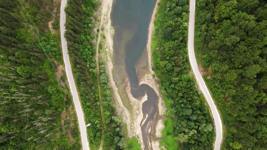 Scenic aerial view of winding river and lush forest surrounding remote area