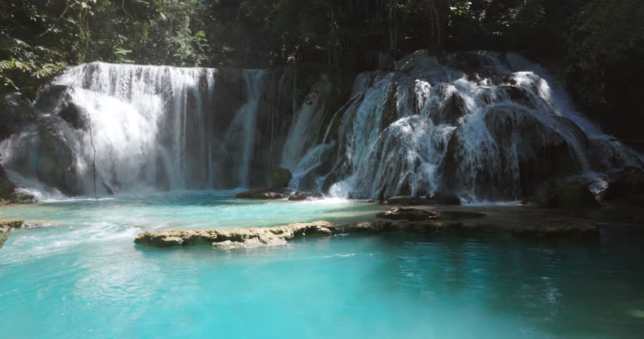 Scenic cascade waterfalls with blue water in natural pool in Central Sulawesi