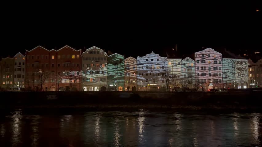 Innsbruck in Austria Tyrol with traditional buildings and Alpine peaks panoramic view at night in a beautiful color 4k