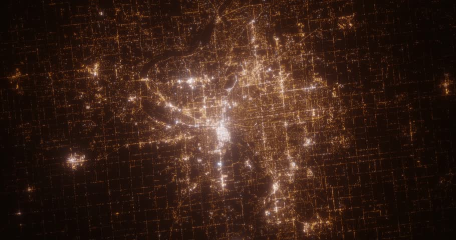 Grand Rapids (Michigan, USA) top view at night. View on modern city from satellite. Camera is zooming in, rotating counterclockwise. Vertical video. The north is on the left side