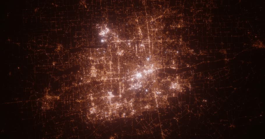 Columbus (Ohio, USA) top view at night. View on modern city from satellite. Camera is zooming in, rotating counterclockwise. Vertical video. The north is on the left side