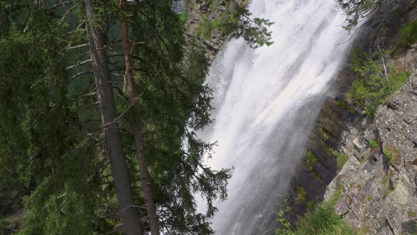 View of large Stuibenfall waterfall in green forest in Tirol alps nature