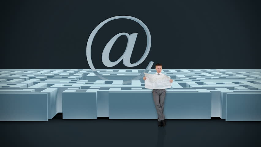 Businessman with Map trying to find his way in a Maze with Internet Mail Sign,