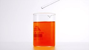 A vibrant red liquid dispersing into clear water in a glass beaker, creating dynamic patterns. Ideal for concepts of chemistry, diffusion, and fluid dynamics. - Powered by Shutterstock - Get 15% off with code: PIKWIZARD15