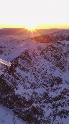 Golden sunrise over snowy Alps, stunning vertical mountain views