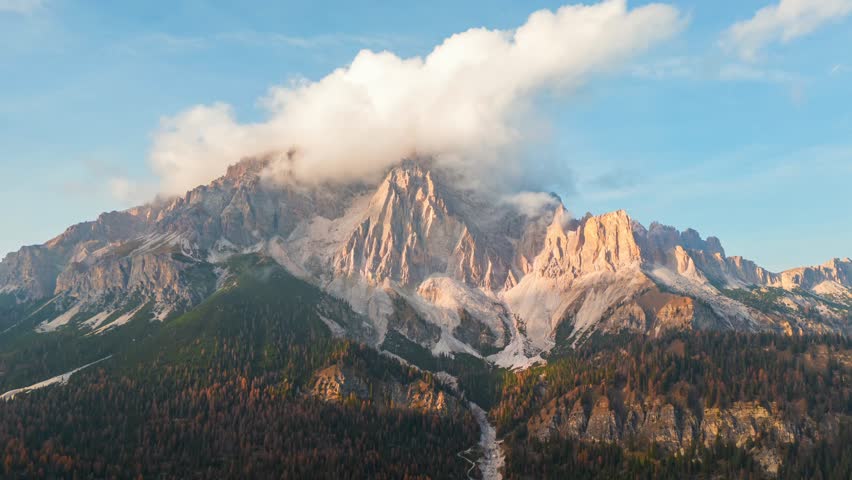 Aerial hyperlapse of high mountain peak with clouds in Dolomites, Italy