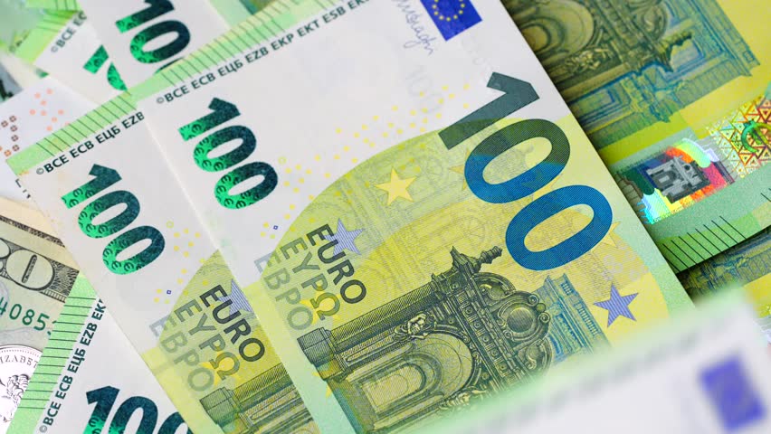 Closeup examination of hundred Euro banknotes, showcasing its features