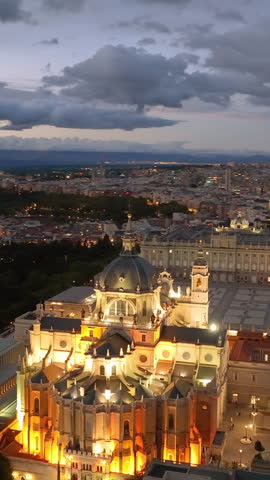 Aerial Vertical view of skyline at Santa Maria la Real de La Almudena Cathedral and the Royal Palace at sunset time. Madrid, Spain