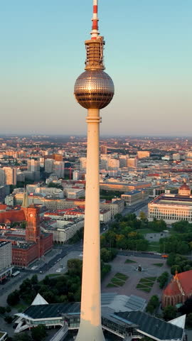Aerial Vertical view of Sunset view over Berlin showcasing the iconic TV tower and city skyline with colorful clouds in the evening sky