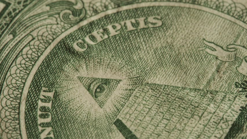 Close up of the Eye of Providence on United States dollar bill. Illuminati and conspiracy theories concept