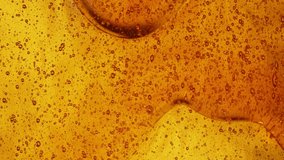 Close-up slow motion shot of pouring yellow caramel or fresh honey with air bubbles, seamless dripping sweet liquid syrup drip flows, thick organic honey dripping, golden caramel sauce flowing - Powered by Shutterstock - Get 15% off with code: PIKWIZARD15