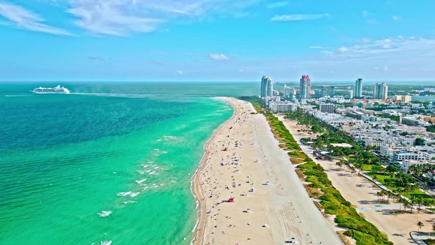 Coastline of Biscayne Bay. Miami south beach aerial view. Summer vacation at Biscayne Bay. Cruise ship at port Miami, Florida. Ship cruise liner passing Miami beach. Aerial drone view. Ocean cruise