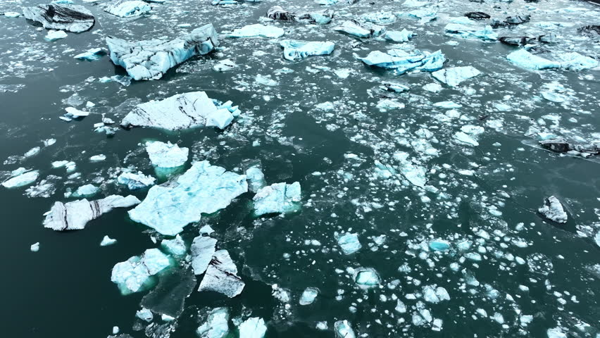 Iceberg in the ocean, Huge chunks of blue glacier ice floating on the waves, Arctic nature in Iceland