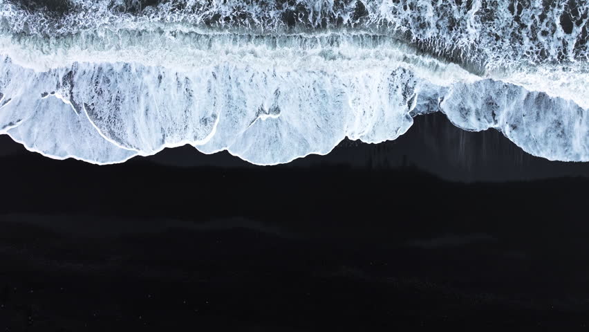 Black sand beach with crashing waves, Serene and tranquil landscape, Ocean coast with calm waves, Famous landmark of Iceland, Black sand of volcanic origin aerial view