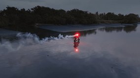 Red burning signal fire in hands of girl on motorcycle. Man and woman in love ride or drive bike in Bali. Journey to ocean or sea, sunset. Travel and freedom. Road trip in Indonesia, aerial drone - Powered by Shutterstock - Get 15% off with code: PIKWIZARD15
