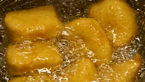 Closeup slow motion crispy fried chicken meat nuggets deep frying in boiling oil - Powered by Shutterstock - Get 15% off with code: PIKWIZARD15