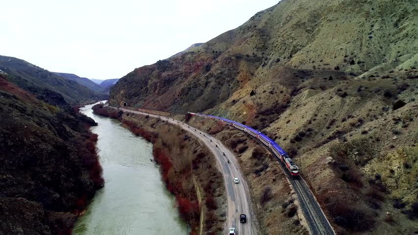 
In autumn,a narrow-gauge railway in a small town hosts trains traveling near the river. Trains run on tracks, carrying cargo or passengers, powered by locomotives or motors, unlike maglev trains.