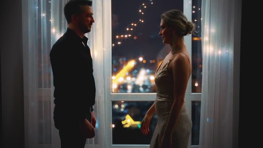 Dark Silhouette Two people man dancing with elegant sexy woman dance near panoramic window black view of night city lights. Happy romantic couple in love. Valentine