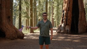 American flag outdoors. Man holds usa national flag against blue cloudy sky in the woods. 4th July Independence Day. Memorial and Veterans Day. National waving flag of the United States. - Powered by Shutterstock - Get 15% off with code: PIKWIZARD15