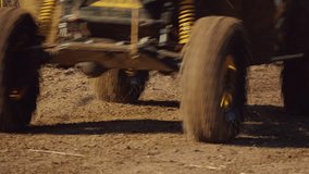 Close-up of the wheels of an off-road buggy spreading mud while racing on a muddy dirt road. Extreme sports on cars. Slow motion - Powered by Shutterstock - Get 15% off with code: PIKWIZARD15