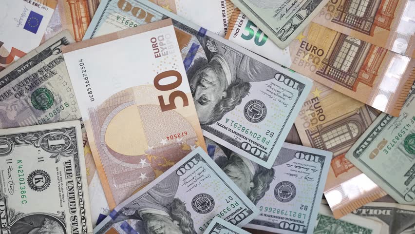 Table cluttered with euro and dollar notes captures essence of forex trading with investors speculate on currency values to profit from fluctuations between currencies