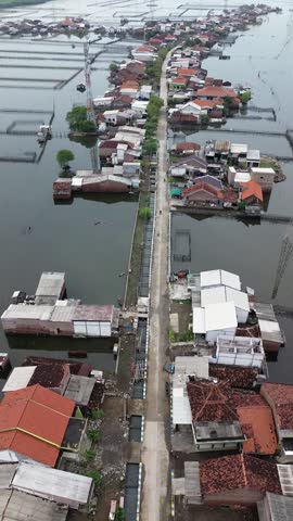 An area in Demak, Central Java, Indonesia, experiences daily tidal flooding, leading to land erosion and the destruction of houses. This is a direct impact of climate change and global warming.