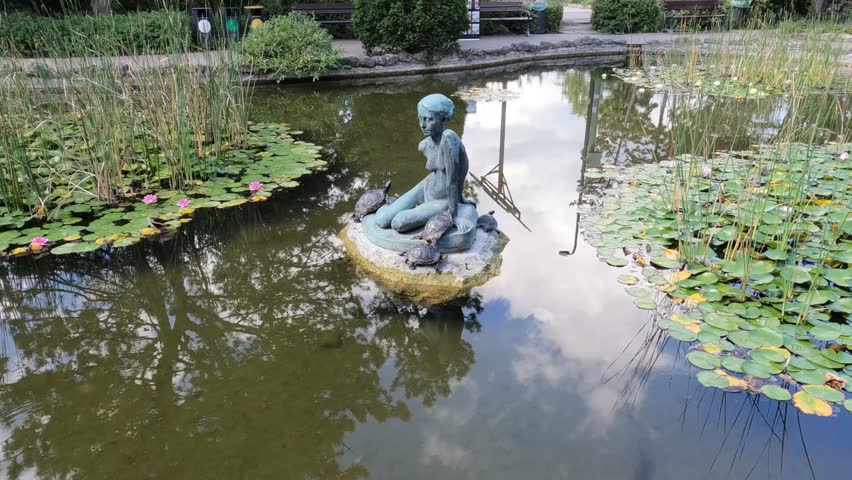 Japanese Garden on Margaret Island with fish pond and statue of sitting girl with turles, Margit Sziget, Budapest, Hungary - 15 September, 2023