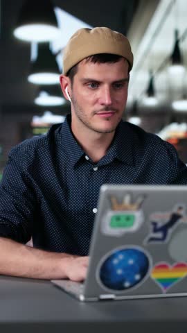 Graphic Photo Designer Using Computer Screen In Coffee Shop