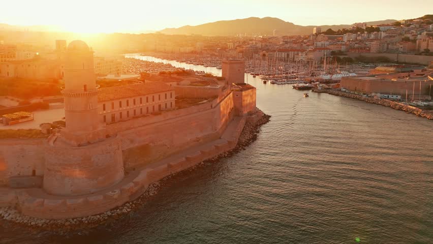 Aerial view of the historic Vieux Port in Marseille at sunrise, southern France. A beautiful summer morning highlights the Marseille cityscape, the second-largest city in France