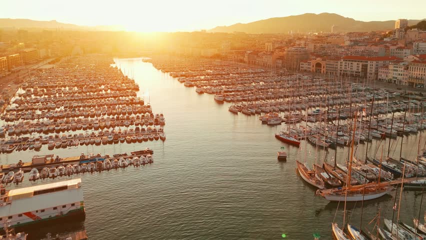 Aerial view of the historic Vieux Port in Marseille at sunrise, southern France. A beautiful summer morning highlights the Marseille cityscape, the second-largest city in France