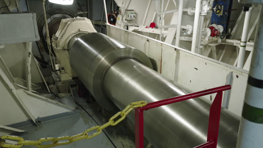 Motor room of ship. Main shaft rotates. Shaft from engine to propeller