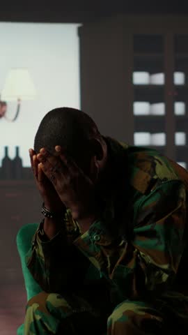 Vertical Video Distraught soldier in tears sharing his struggles with war PTSD, attends therapy session with expert for rehabilitation. Psychological support and society reintegration for veterans