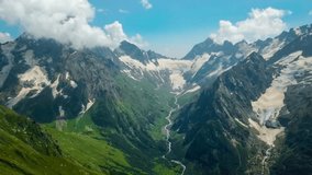 Aerial drone view of mountain landscape glaciers and valley on a sunny day. Dombay, North Caucasus, Karachay-Cherkessia. High quality 4k footage - Powered by Shutterstock - Get 15% off with code: PIKWIZARD15