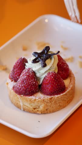 Delicious Strawberry Tart with Creamy Topping and Chocolate Decor