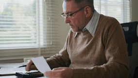 senior calculating his savings account for check balance and his plan in retirement period is going well, Ageing society and retire fund concept - Powered by Shutterstock - Get 15% off with code: PIKWIZARD15