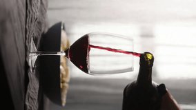 Vertical pour red wine into wineglass with fusilli pasta on background - Powered by Shutterstock - Get 15% off with code: PIKWIZARD15