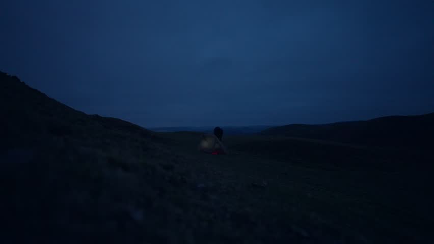 Dark Hill with a Man Leaving His Camping Tent at Dawn