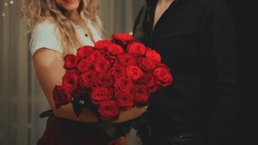 Silhouette Romantic man giving gift luxurious bouquet of flowers red roses to woman. Happy couple in love Valentine's Day. guy comes on date with girl. night dark cozy room. cropped face joy family 4k - Powered by Shutterstock - Get 15% off with code: PIKWIZARD15