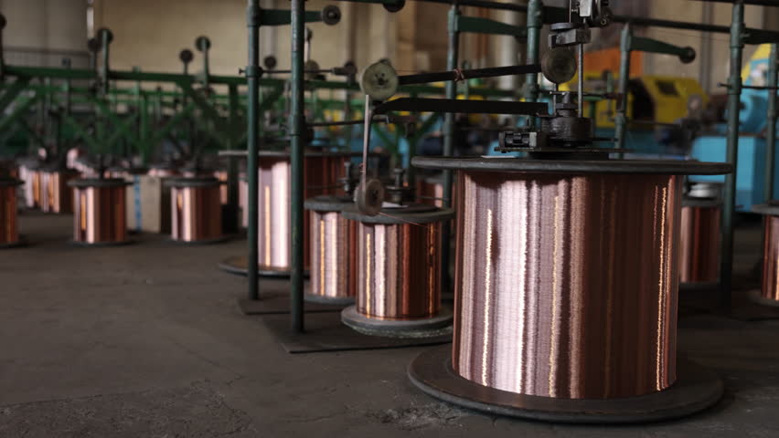 Copper production, Bare copper, Production facility. Numerous oversized copper coils are located within copper wire production facility.