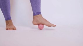 foot massage with a special massage ball. The concept of prevention and treatment of flat feet. - Powered by Shutterstock - Get 15% off with code: PIKWIZARD15