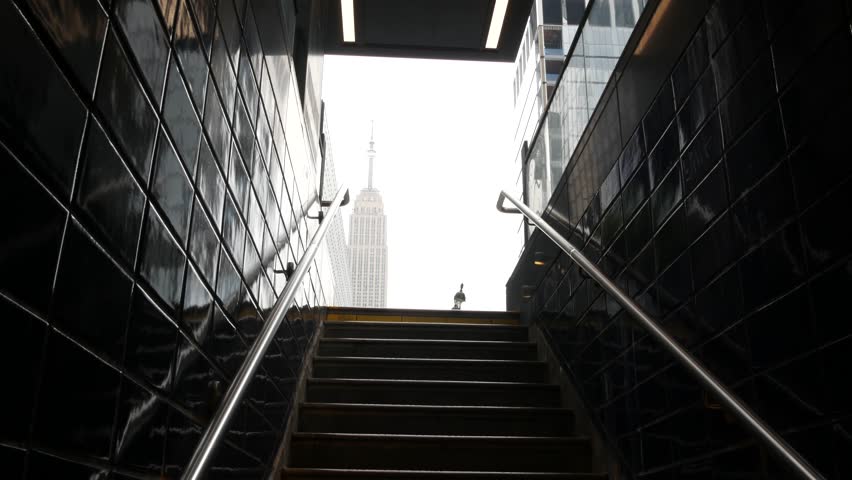 New York City underground subway metro. Empire State building. Metropolitan entrance or exit stairway, Manhattan, 34 street. NYC Midtown financial business district. Public transport station stairs.