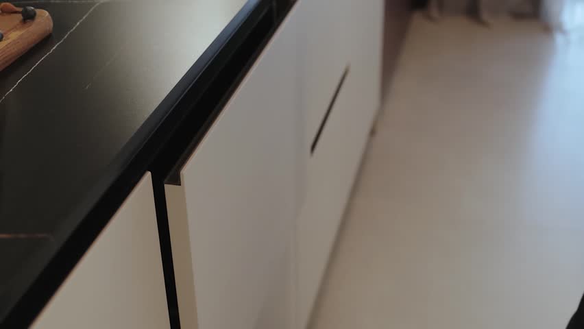 This modern kitchen drawer features a sleek design and ample open space for organization