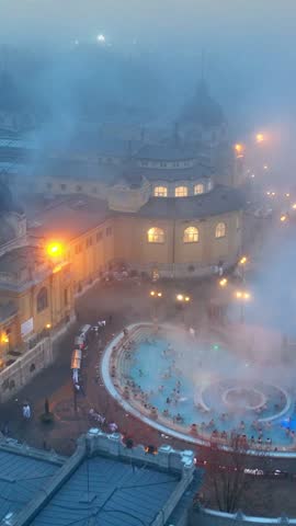 Vertical video: Budapest Szechenyi Thermal Baths in winter, capital of Hungary from a drone, hot springs in Hungary in winter. High quality FullHD footage