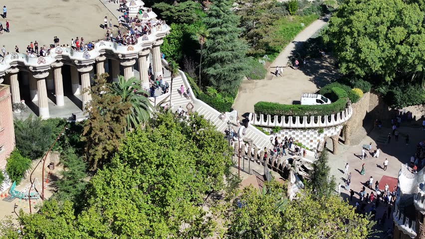 A stunning aerial view of Parc Güell in Barcelona, Spain, showcasing Gaudí's iconic architecture and the vibrant colors of this UNESCO World Heritage Site.