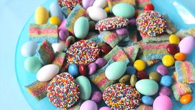 A vibrant blue bowl filled with colorful jellybeans and sugar candies placed on a table, perfect for festive or dessert-themed visuals
 - Powered by Shutterstock - Get 15% off with code: PIKWIZARD15