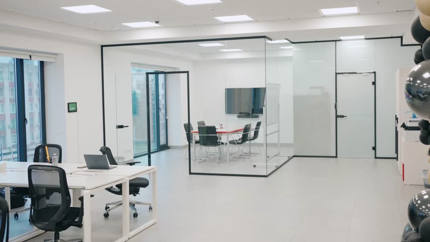 A Modern Office Space that Features a Meeting Room and Attractive Glass Walls for Functionality