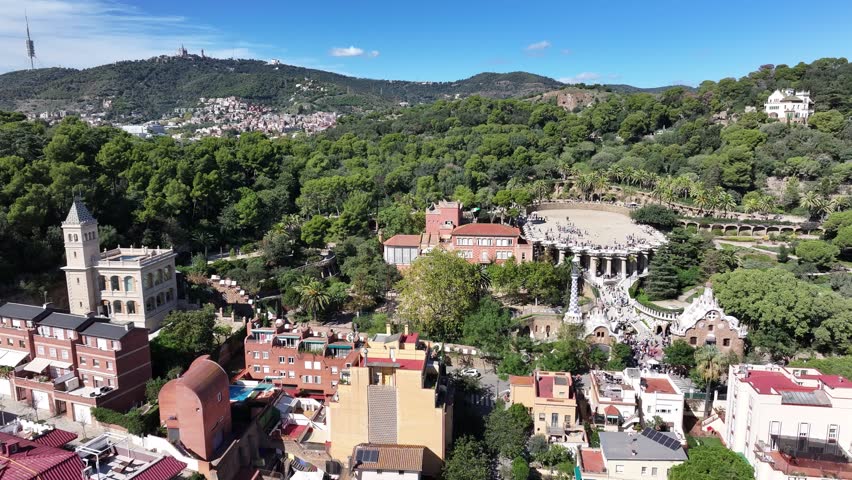 Panoramic aerial footage of Parc Güell, Barcelona, showcasing the stunning layout, vibrant mosaics, and unique Gaudí designs of this iconic UNESCO site.